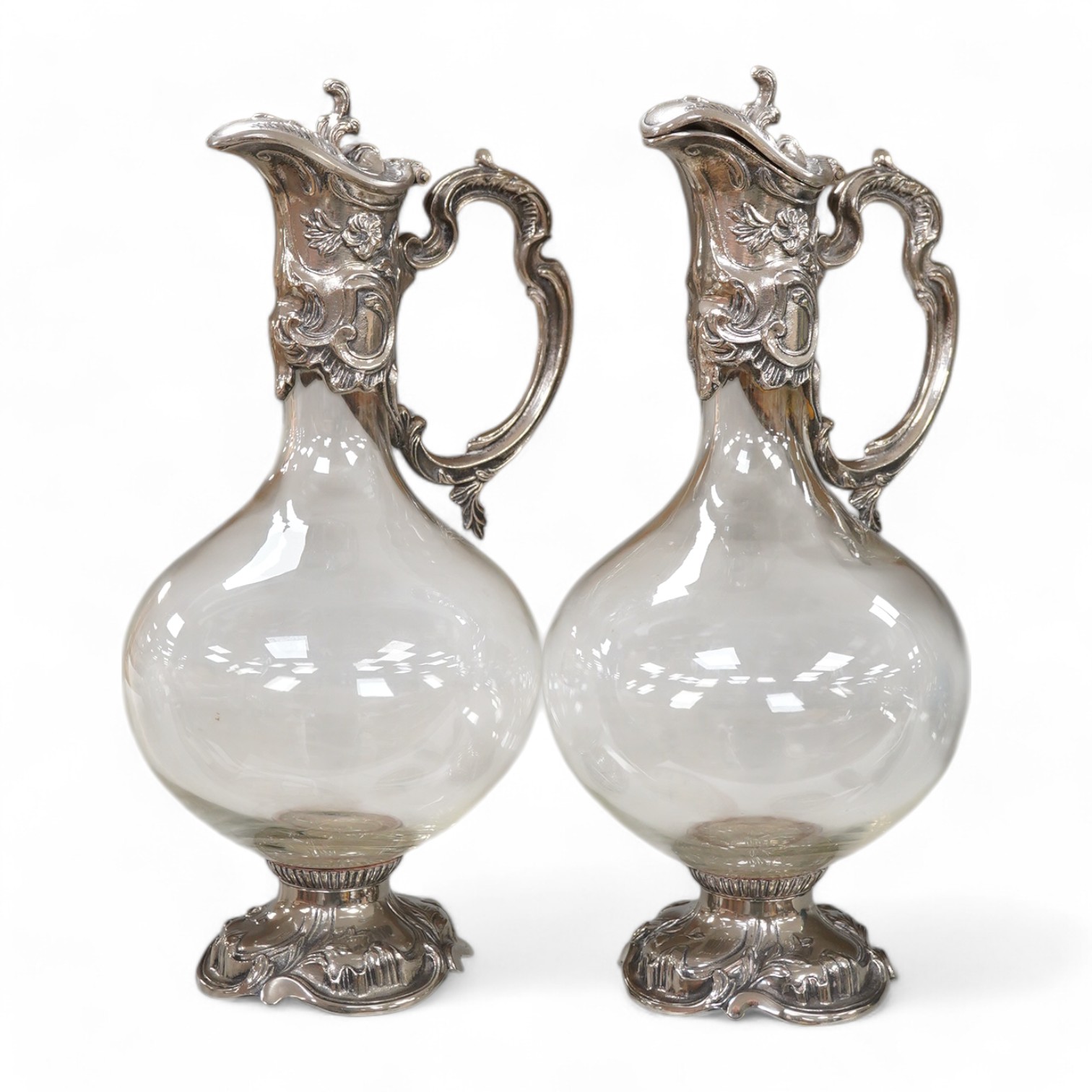 A pair of Art Nouveau style glass and silver plate mounted claret jugs, 31cm. Condition - good